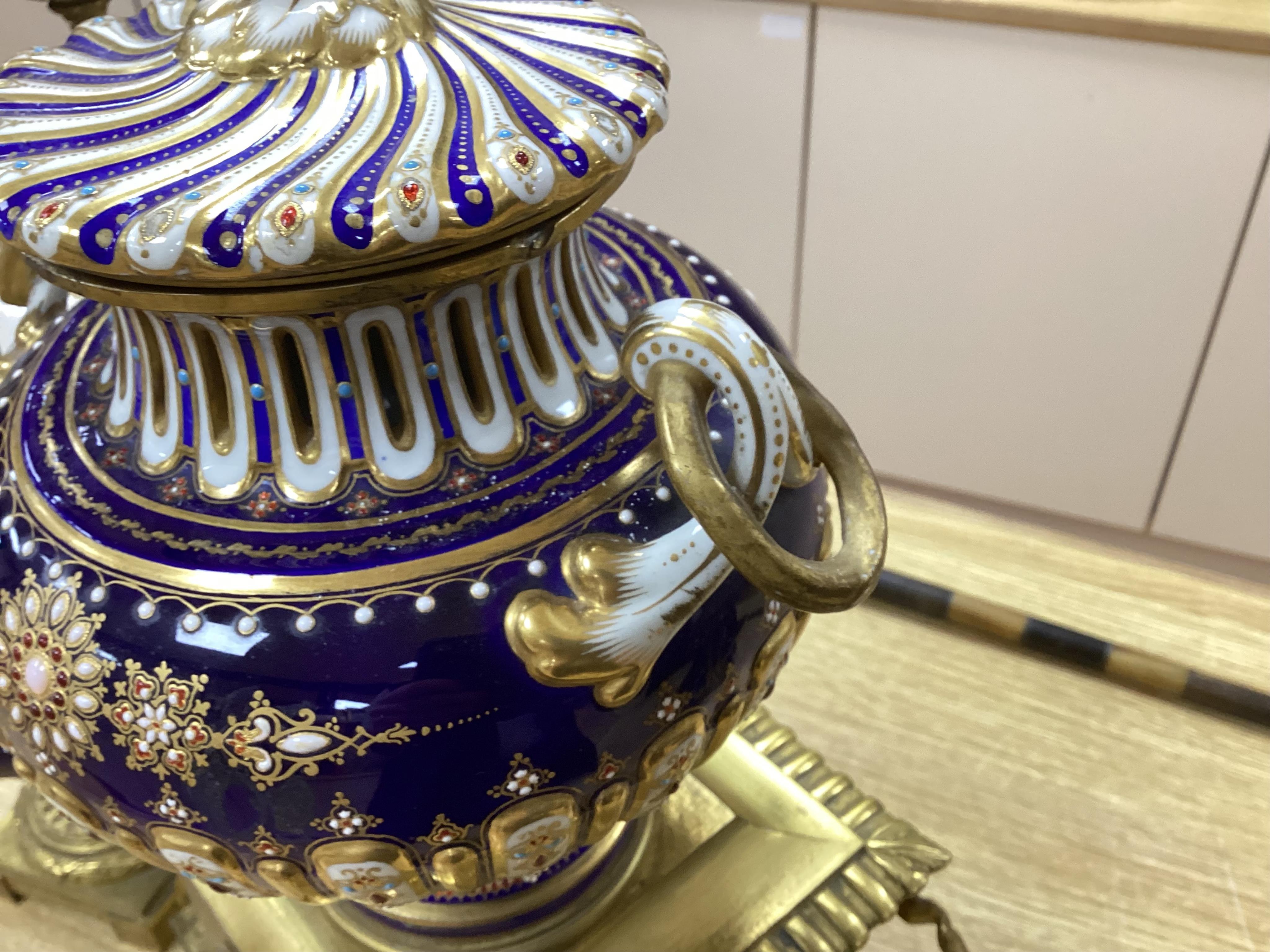 A 19th century Sevres style jewelled porcelain and ormolu matched clock garniture, striking on a bell, with pendulum, 51cm high. Condition - fair to good, minor restoration, untested